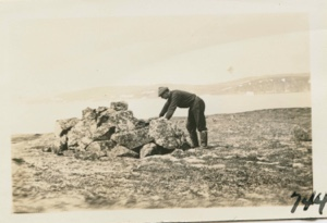 Image: MacMillan looking into Grave